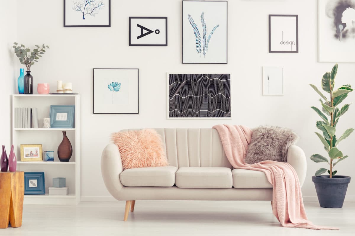 focus wall with artwork on it and couch in front