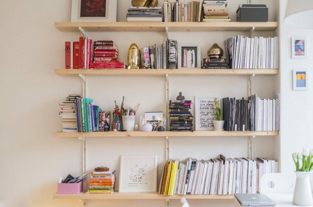 books and items on shelf in bedroom