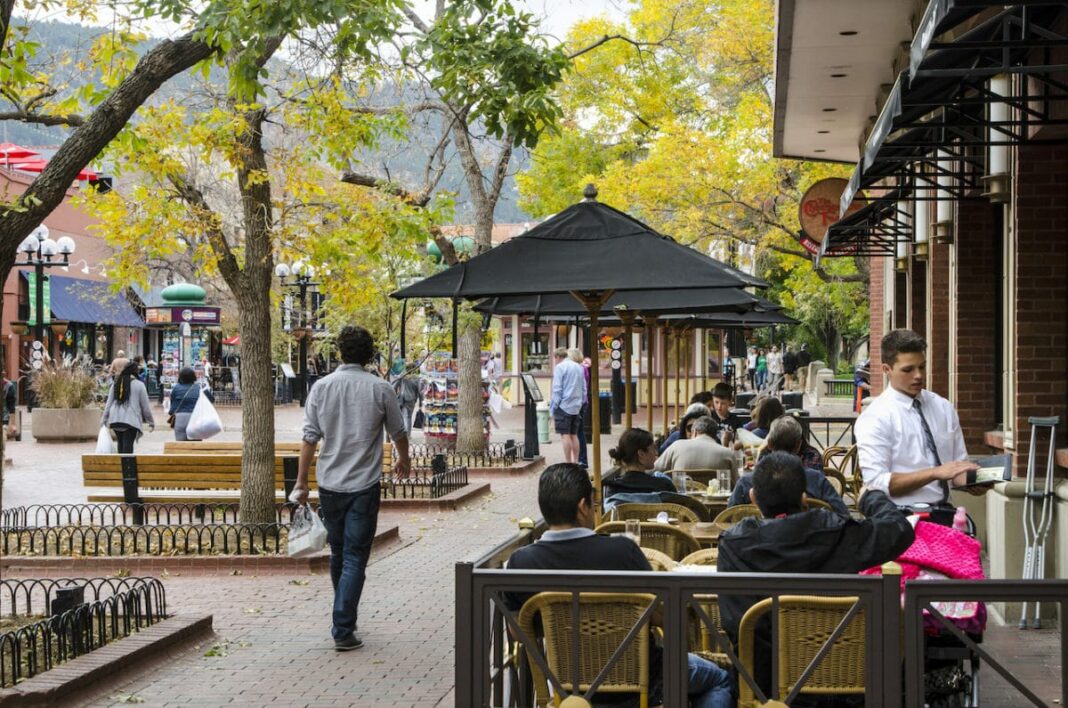 people sitting outside and eating on cute main street