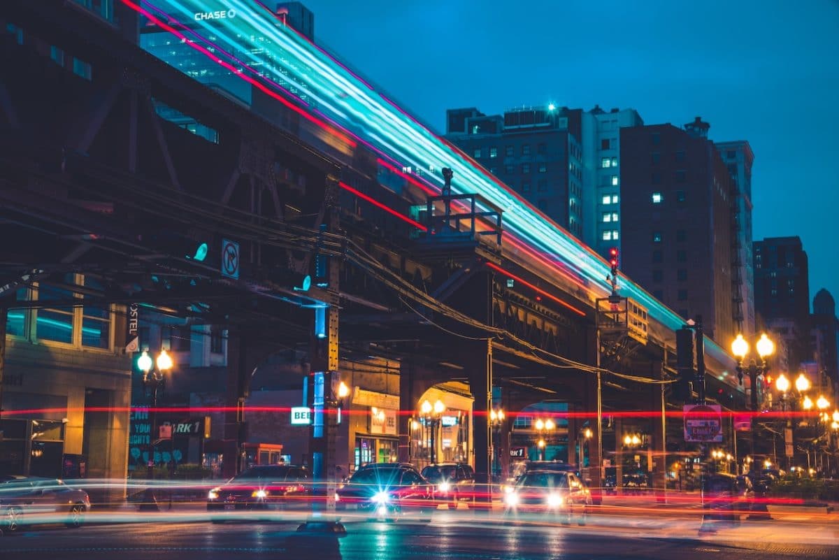 nighttime with train and cars on road