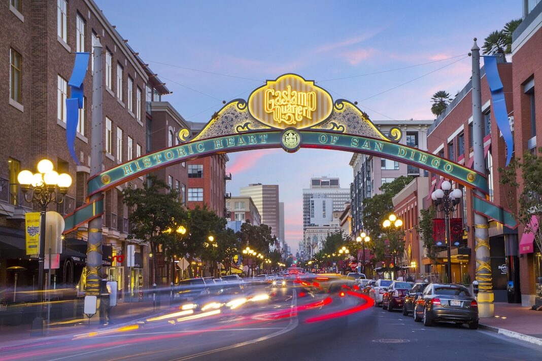 Downtown San Diego Gaslamp sign with traffic moving on street