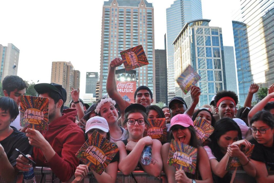 people at an outdoor concert smiling 