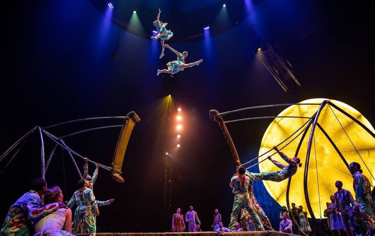 People in a large room doing air acrobats