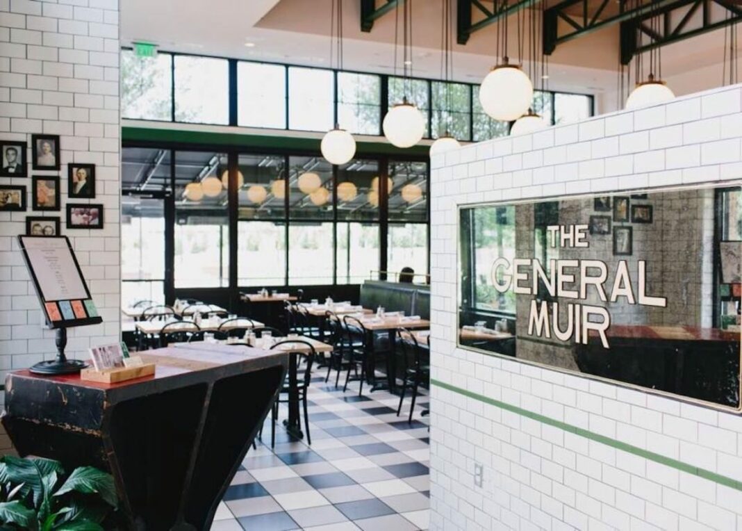 Empty restaurant with "The General Muir" written on glass window