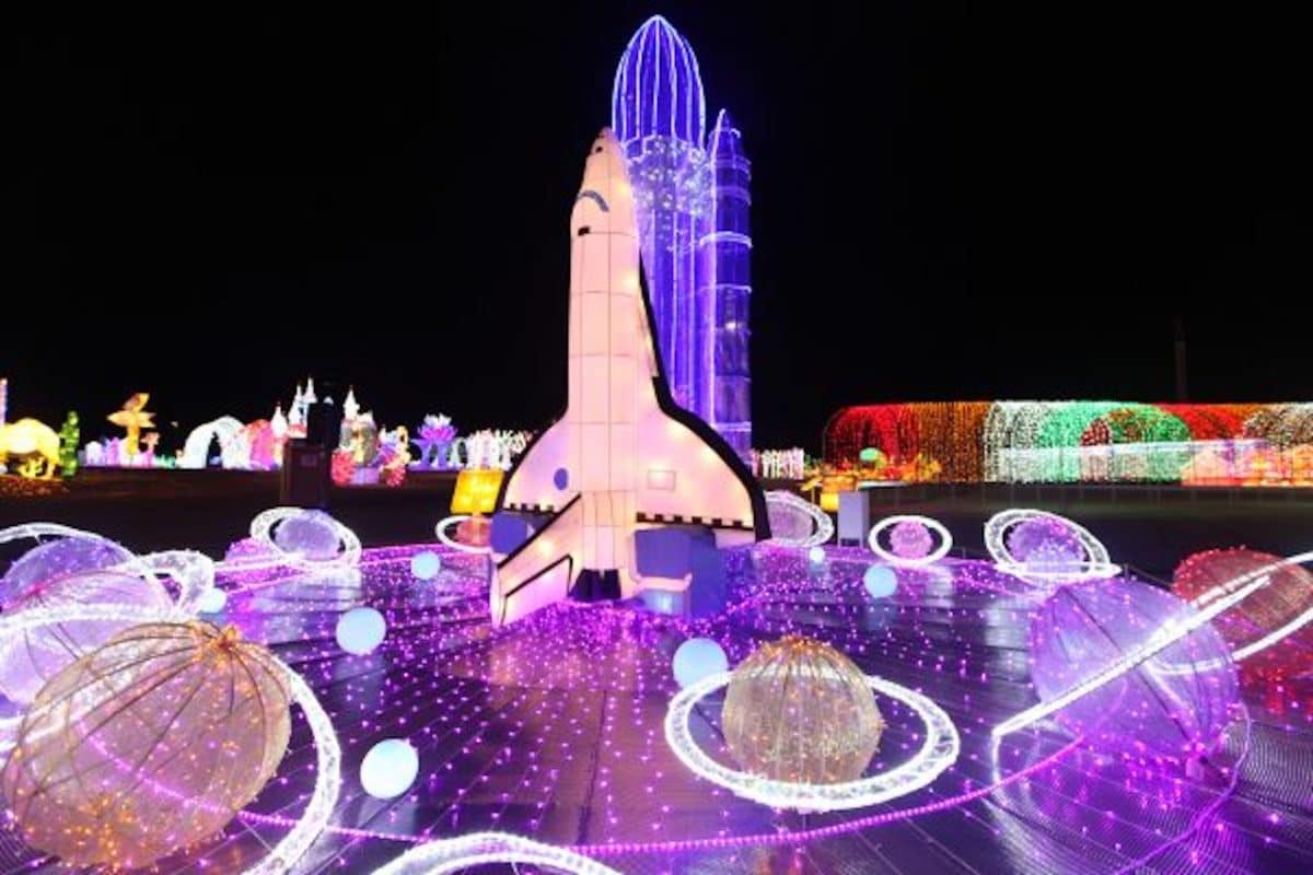 Spaceship and other items lit up at nighttime