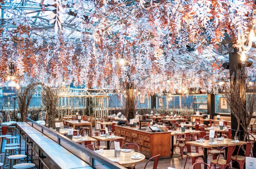 Interior of restaurant with hanging flowers and festive decorations