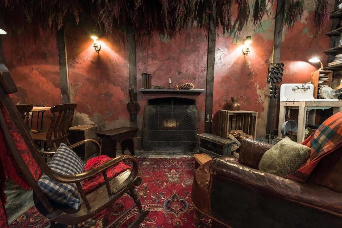 cabin style room with cozy chairs and fireplace