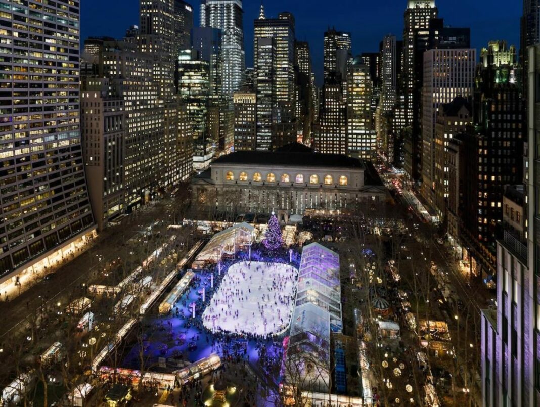 aerial shot of ice skating rink in the middle of cityscape