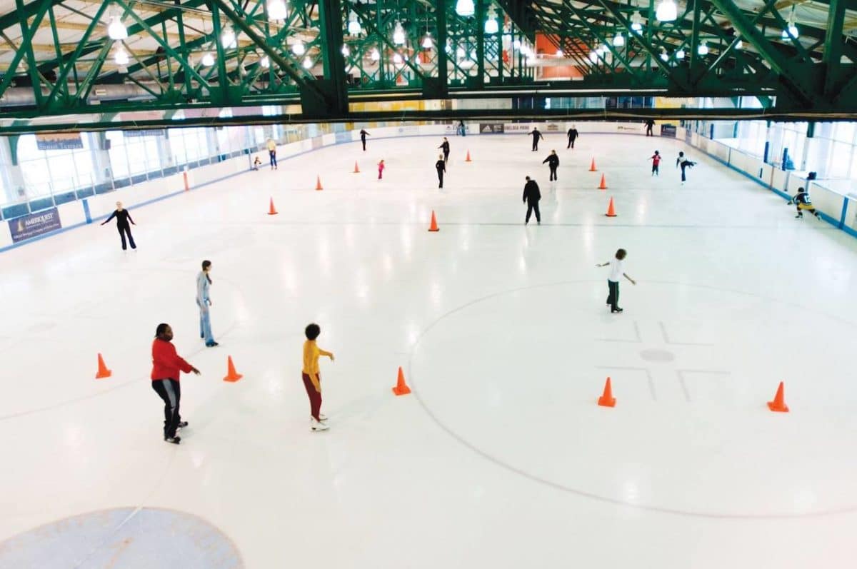 aerial view of ice rink with people skating around cones