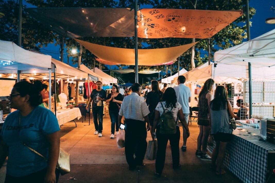 Nighttime market with local vendors and people shopping