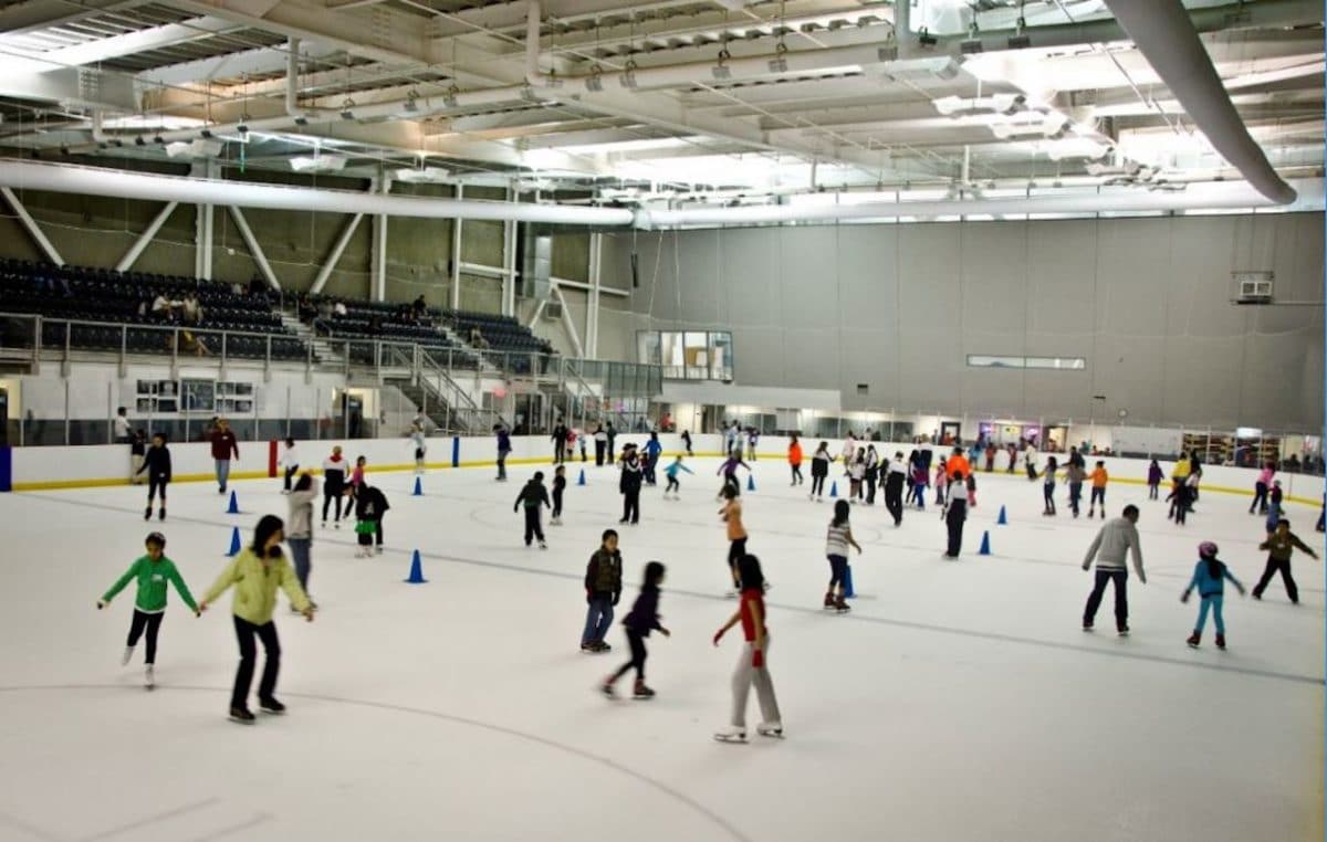 indoor ice rink with people skating on it