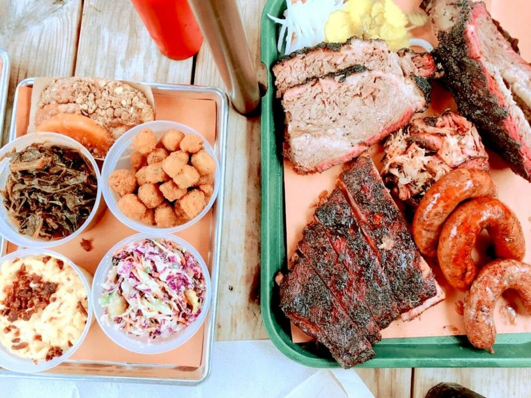 above shot of two bbq plates with sides and meats