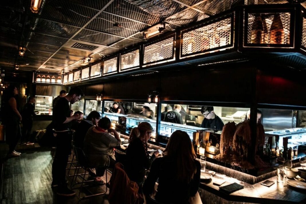 people sitting at restaurant bar at nighttime