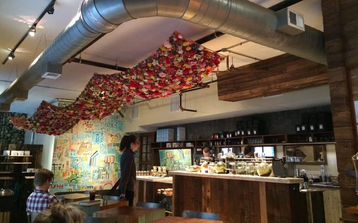 interior of elixr coffee with people sitting and standing throughout