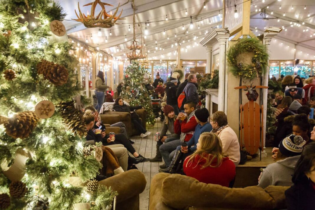 cozy lodge lit with white lights and filled with people sipping on drinks