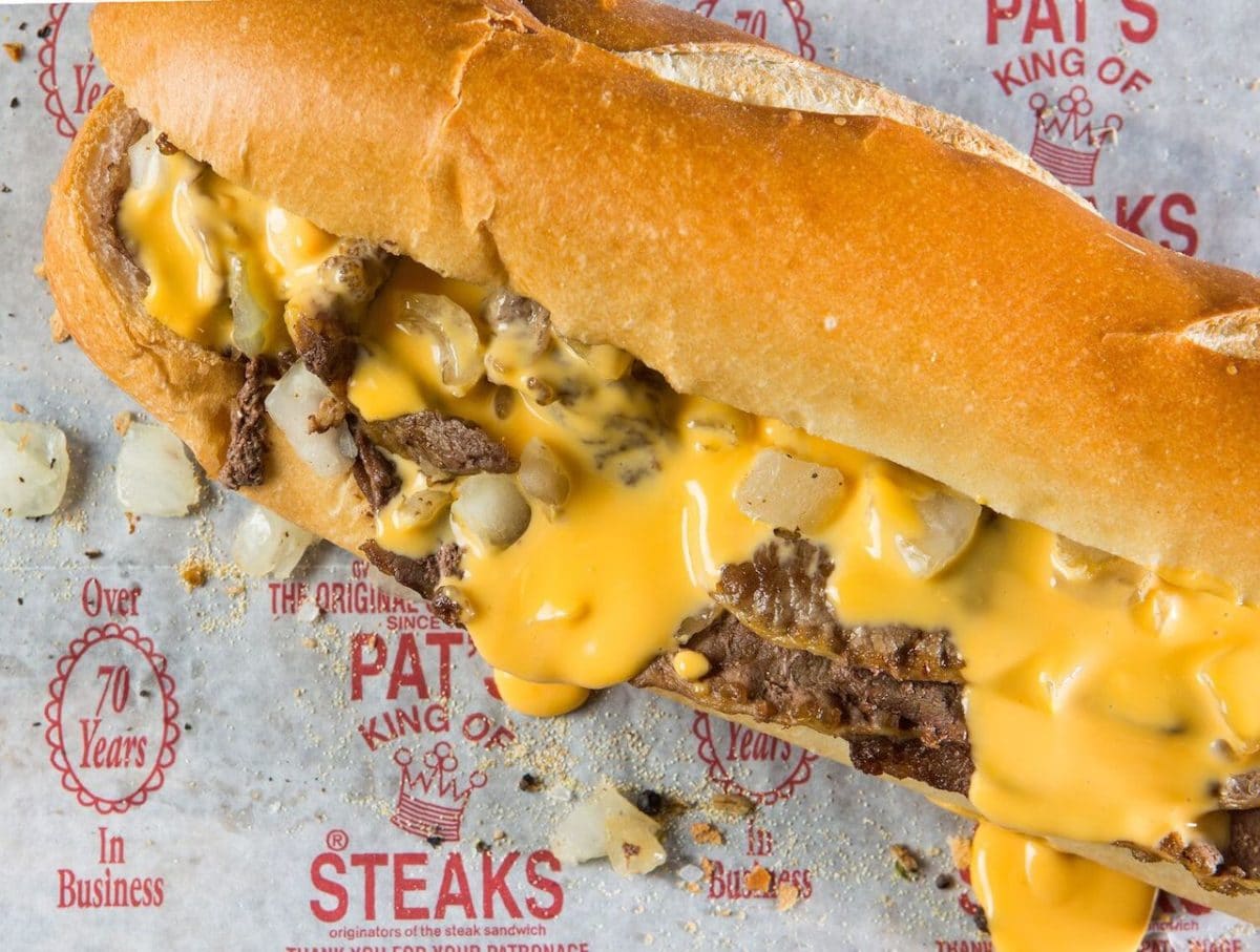 close up of philly cheesesteak on pat's steaks parchment paper