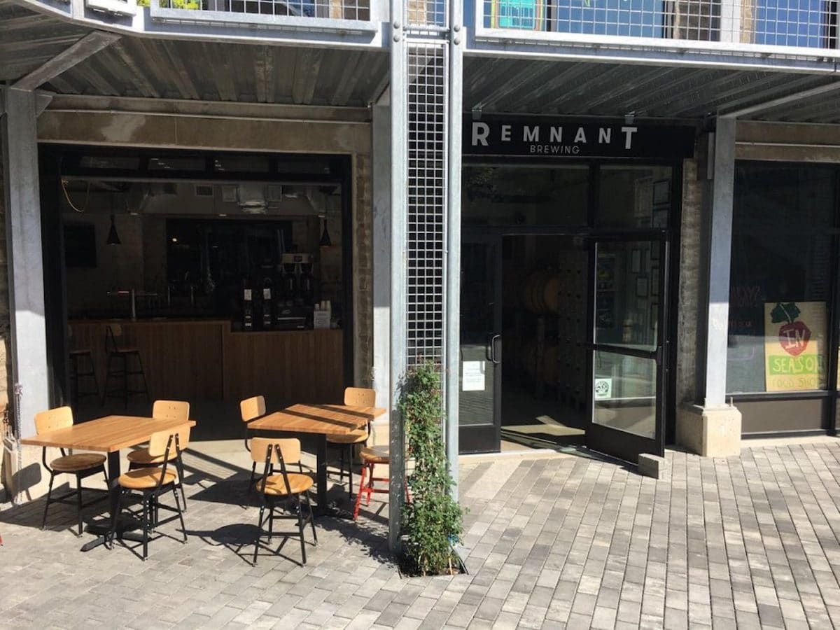 outside of remnant brewing with two tables and chairs set up