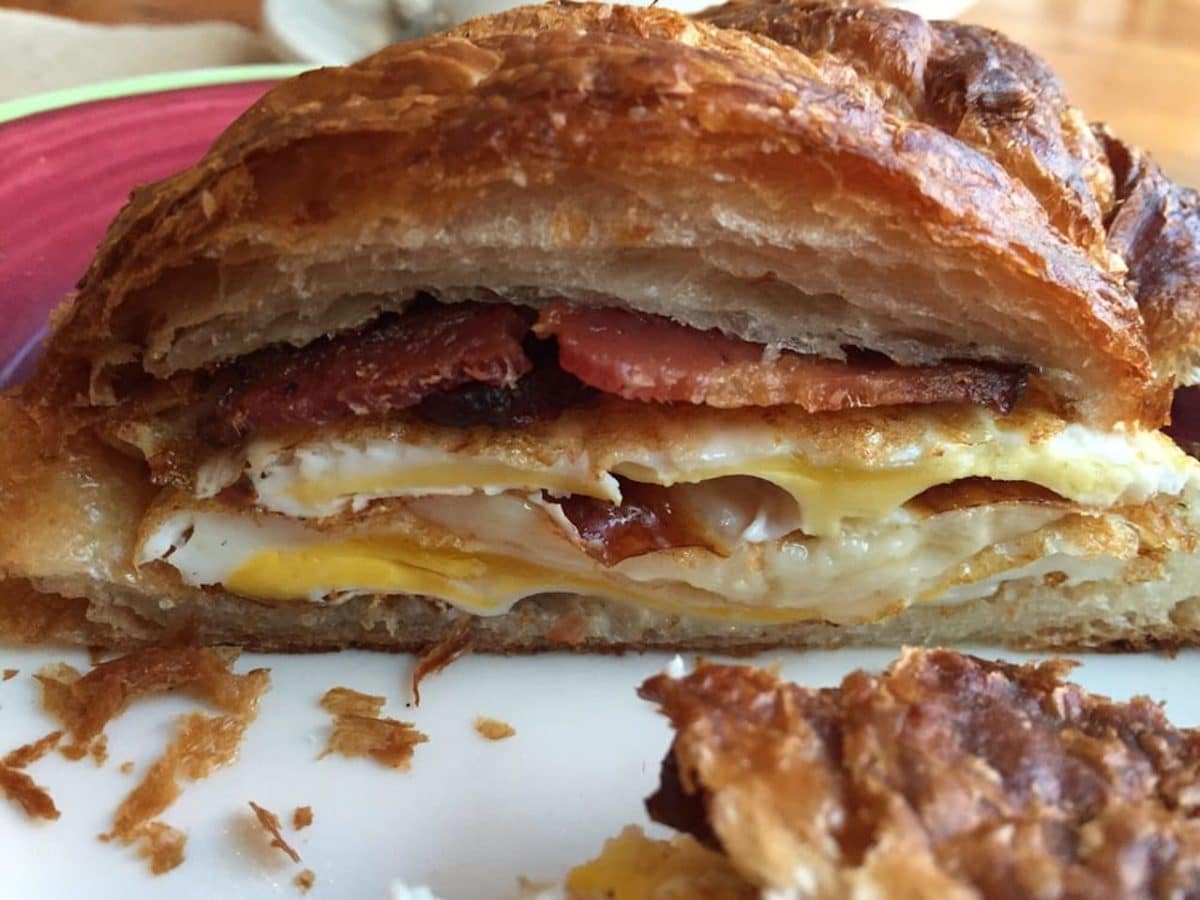 close up shot of breakfast sandwich on croissant