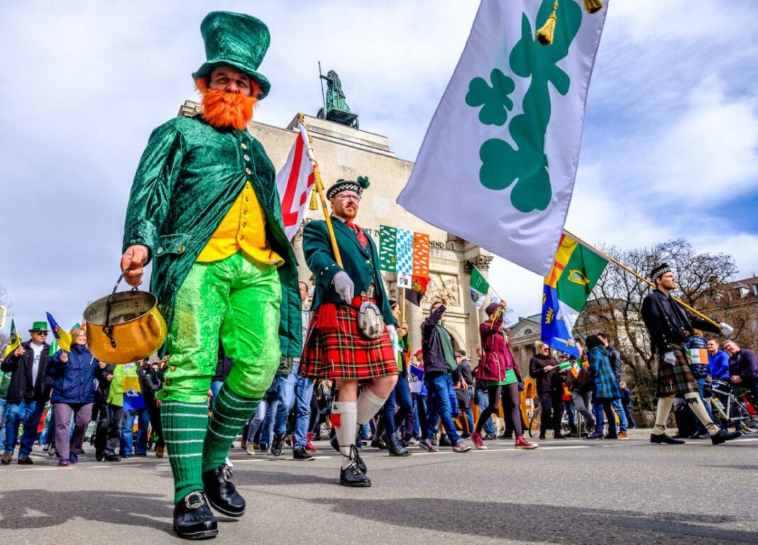 st. patrick's day parade with people in costume and marching