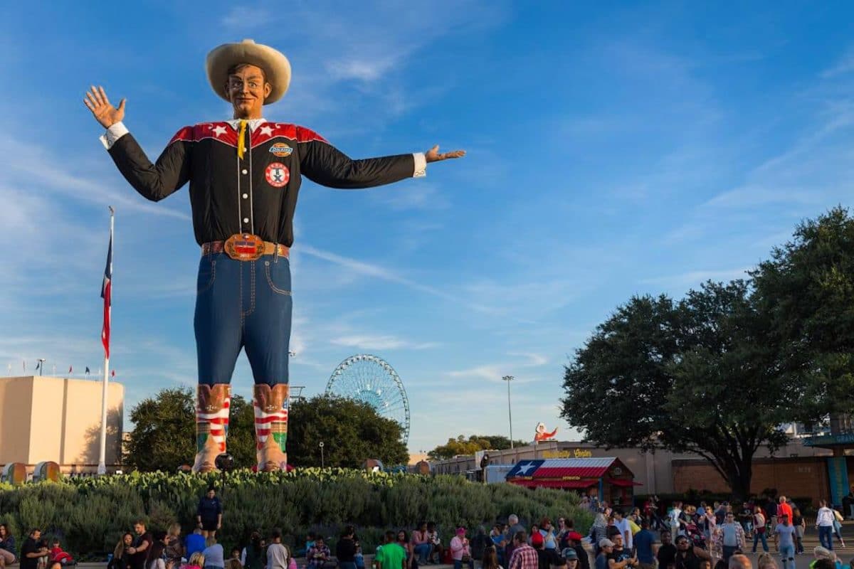 tall statue of cowboy marking entrance of state fair
