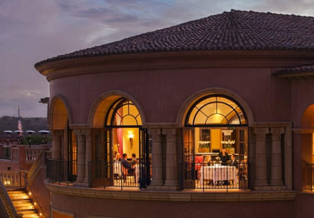 outdoor view of restaurant with people eating in the balcony windows