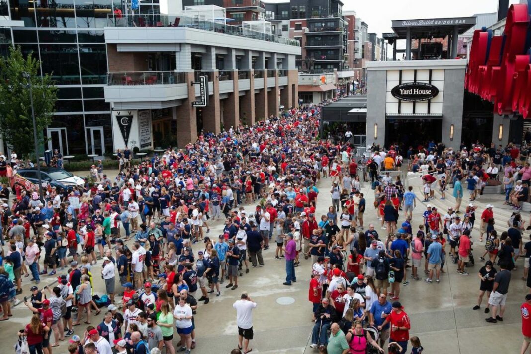 crowd walking and standing while drinking before braves game