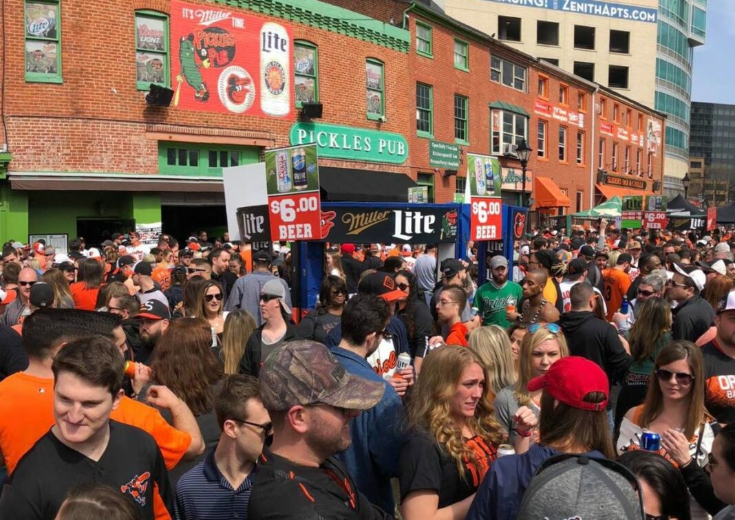 huge crowd of people eating adn drinking in front of pickles pub