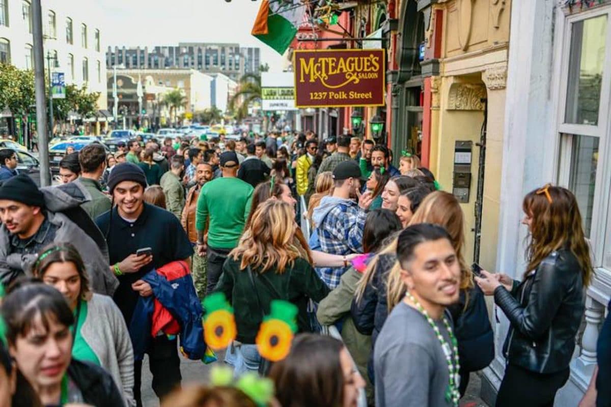 huge crowd on streets outside of irish bars