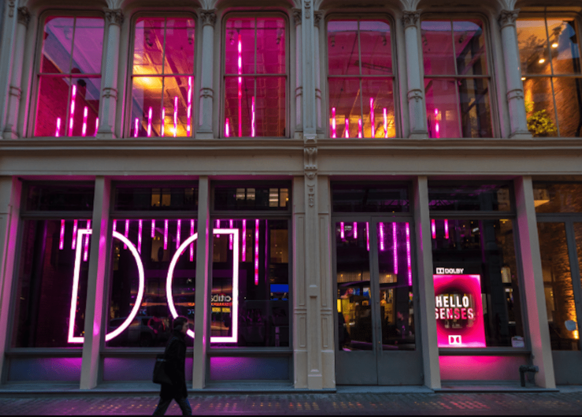 exterior of dolbyb soho building with person walking in front of it at night