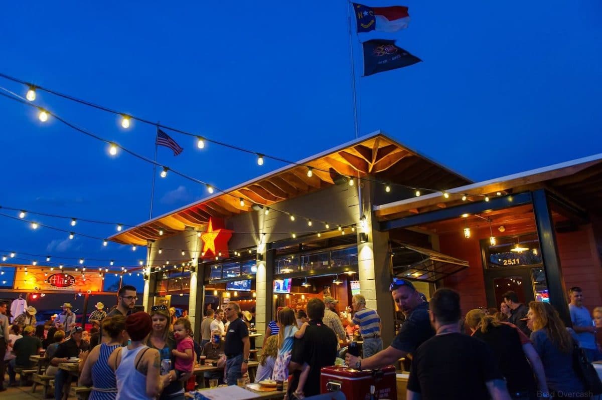 exterior patio of mac's speed shop with people sitting and eating outdoors