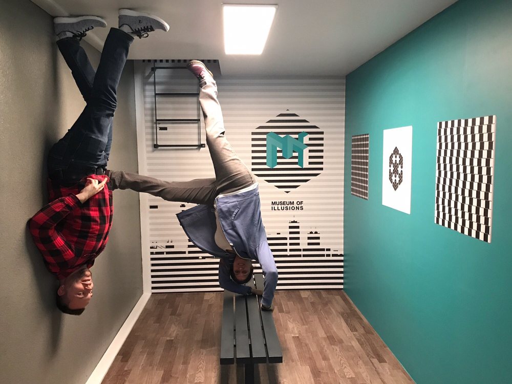person on wall and another person on bench, both upside down 