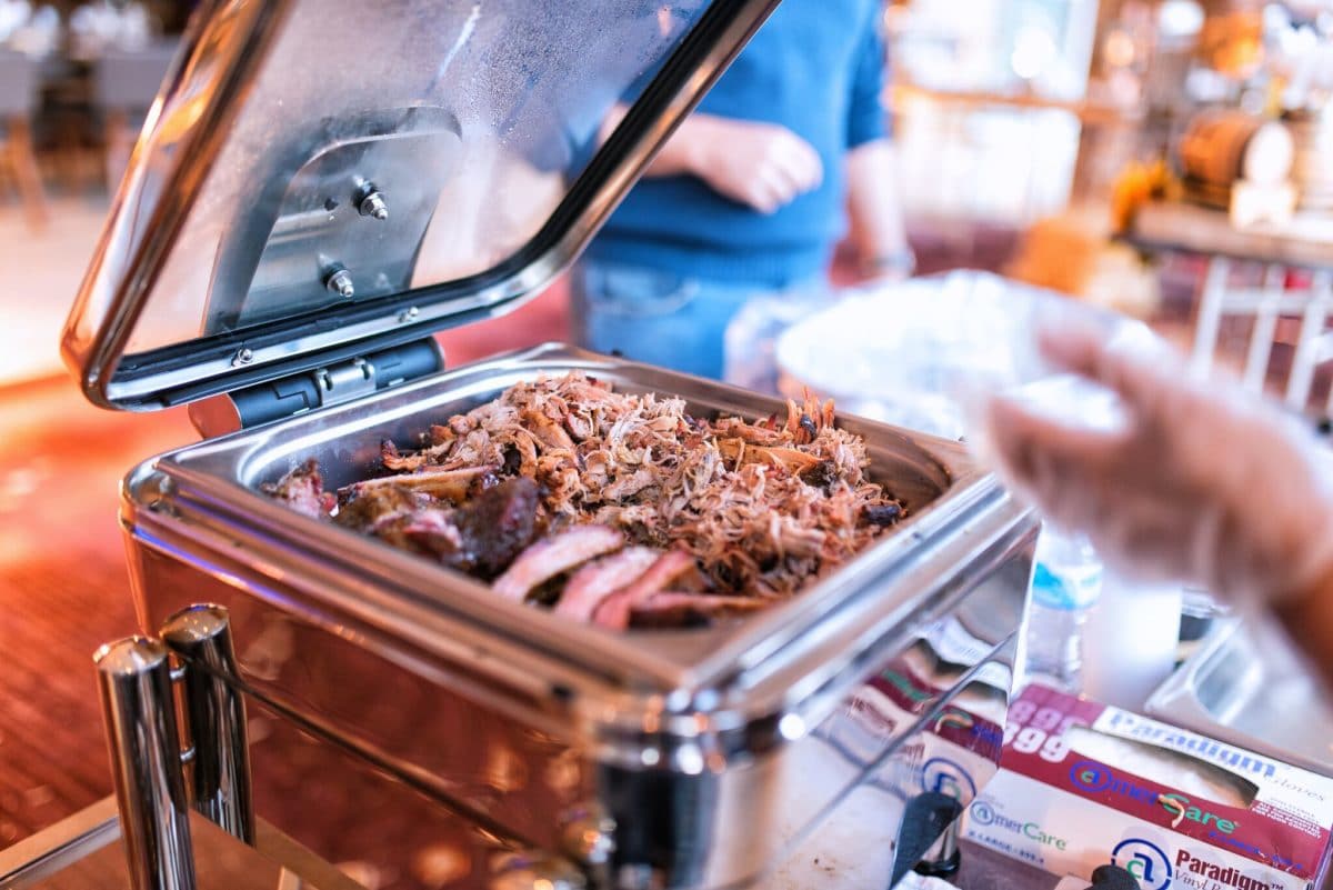 pulled pork simmering in a warmer
