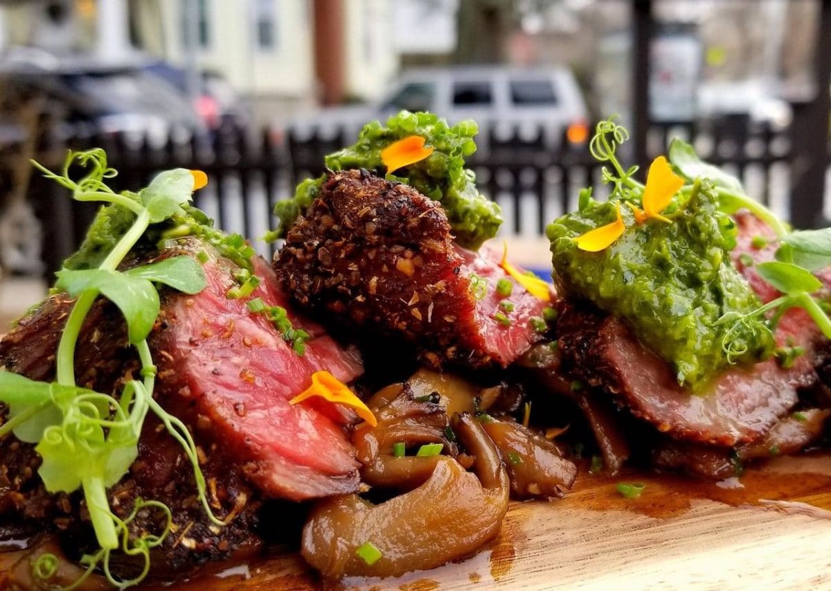 hanger steak on plate with green vegetables