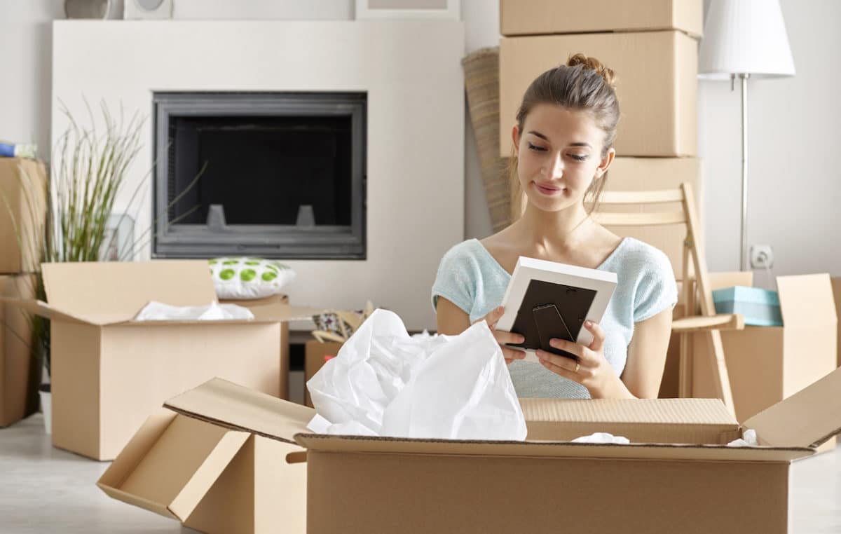 Woman unpacking cardboard boxes