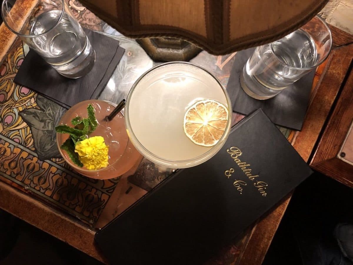 overhead shot of table with drinks and menu on it