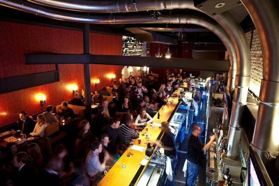 aerial view of bar with people drinking and waiting for service at the bar