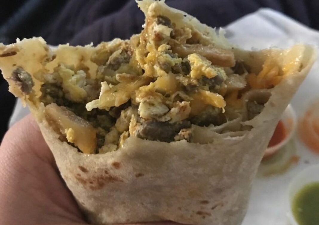 close up of a breakfast burrito with eggs