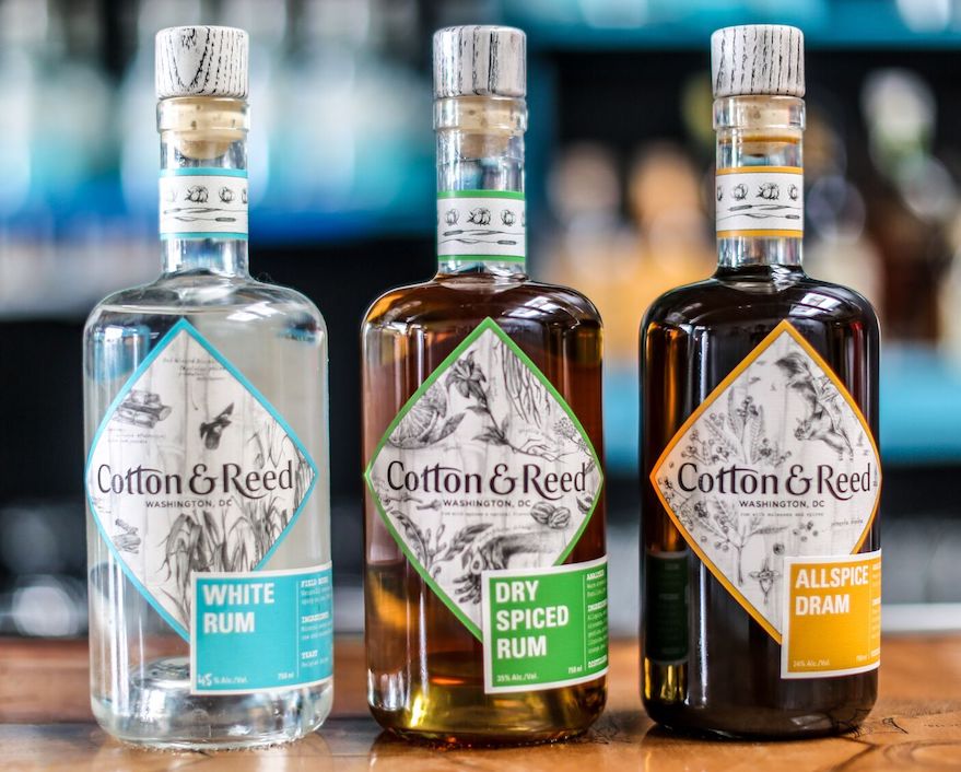 3 bottles of cotton & reed rum on counter