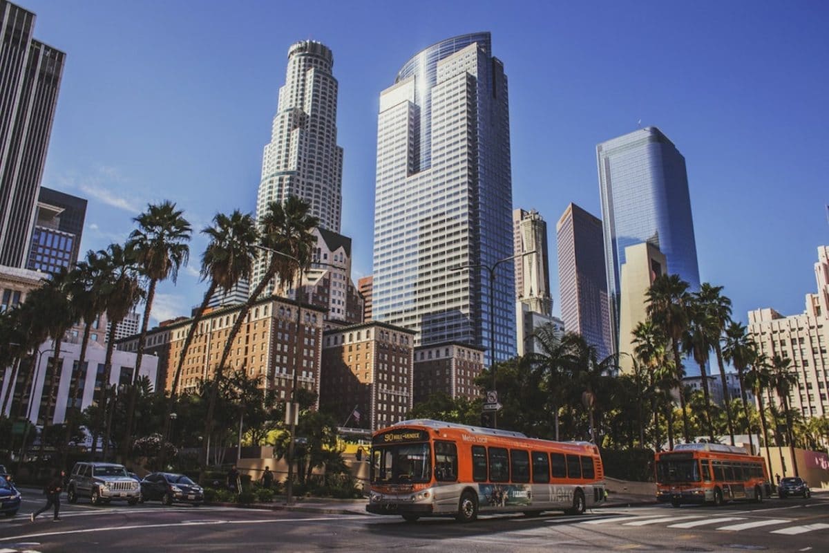 downtown la  with bus driving in front of building under blue skies
