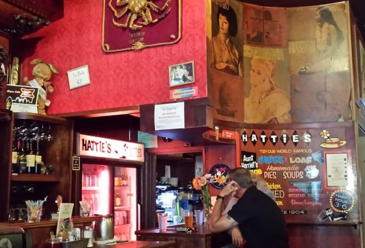 two people sitting at bar with kitschy, red interior