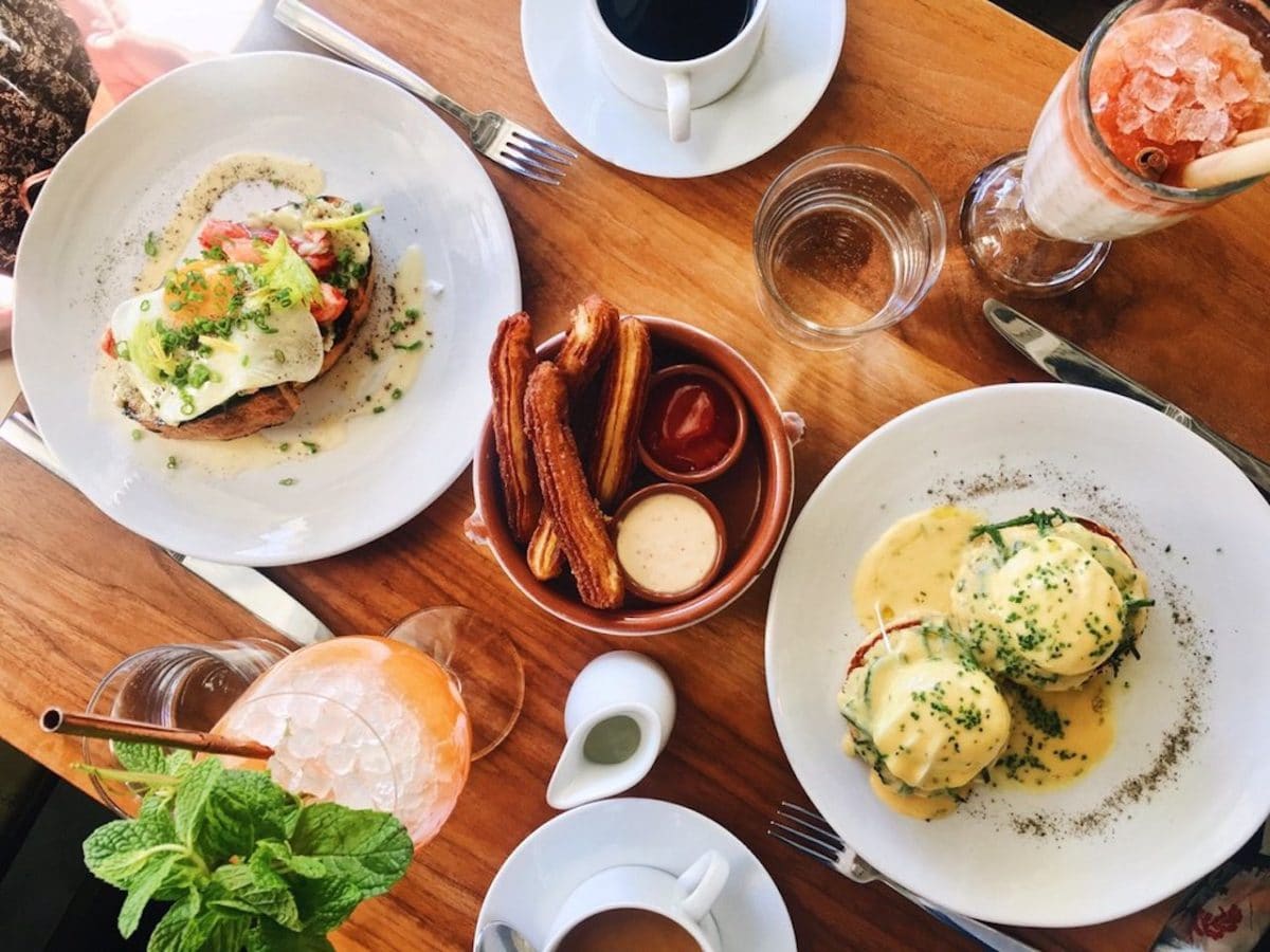 aerial view of table filled with brunch food and drink items