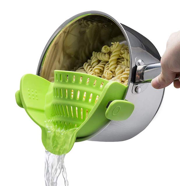 green pasta strainer snapped on to pot that's pouring out water while pasta stays in pot