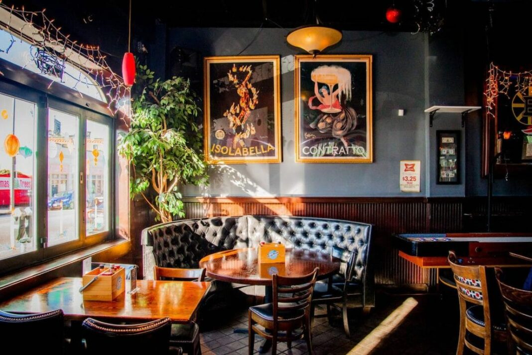 empty booth and shuffleboard table to the right in a bar