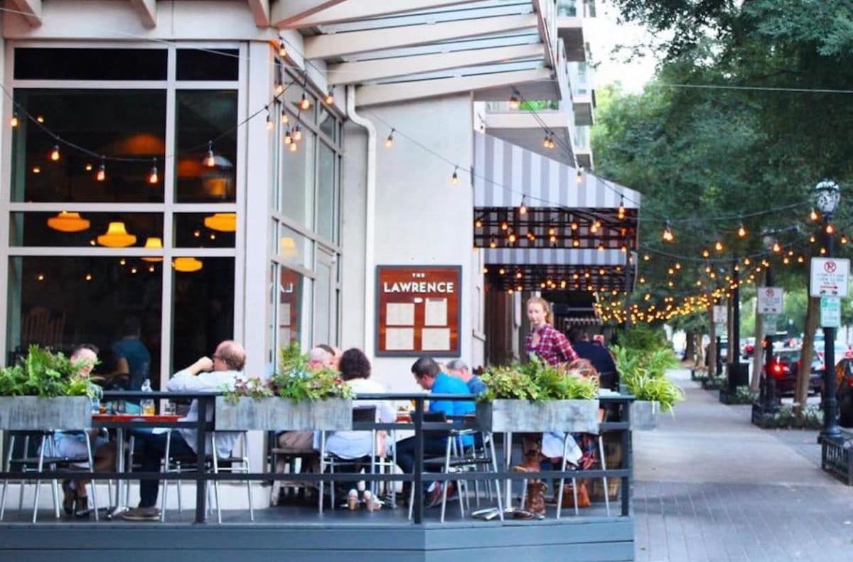 outdoor patio with people eating and drinking on it