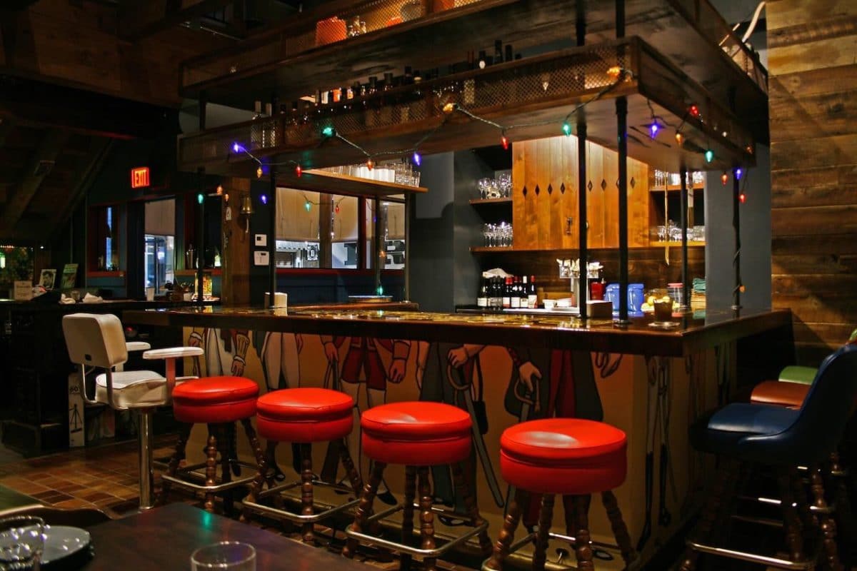 red barstools at bar inside bar/restaurant