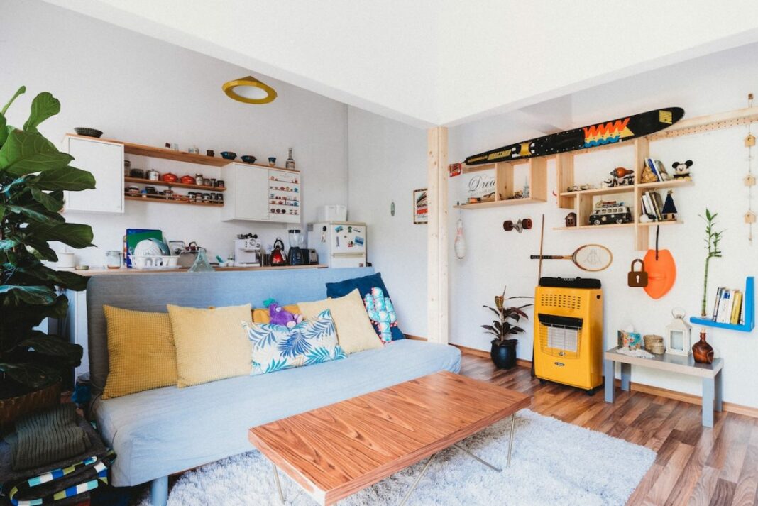 studio apartment with sports equipment on wall
