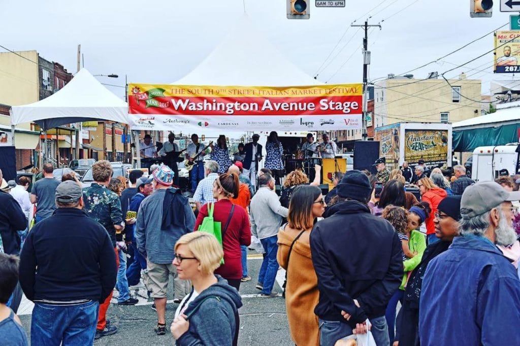 people walking through italian market during festival