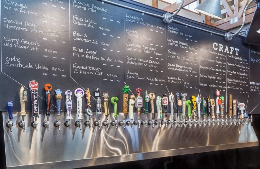 craft beer taps on wall in bar