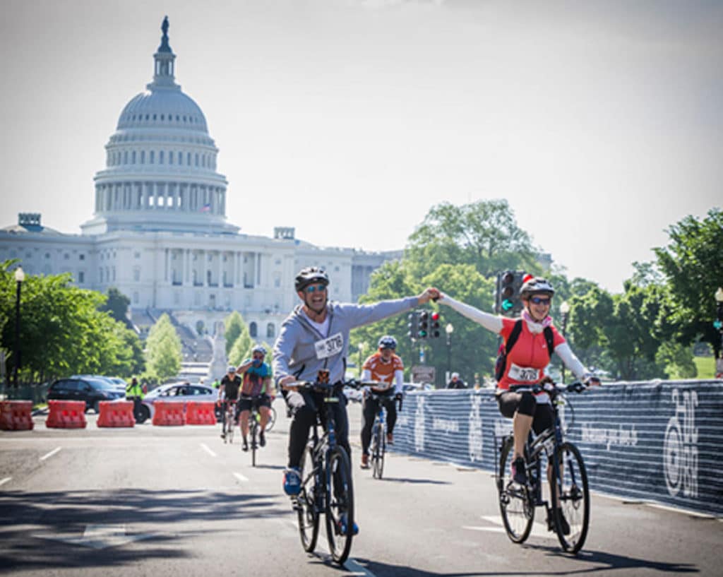 two people high fiving in front of the capitol