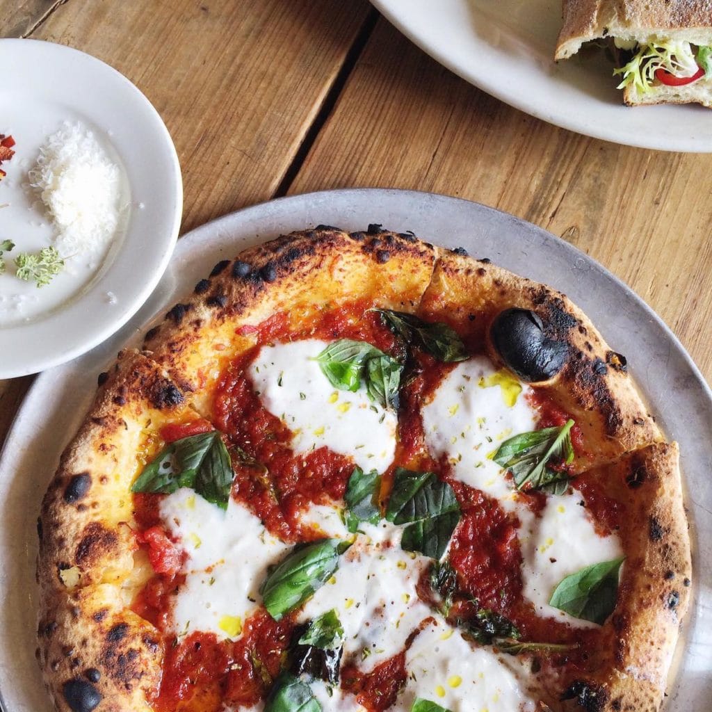 margharita pizza on white plate